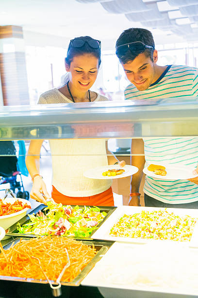 istock tourists getting lunch at the buffet 450210649