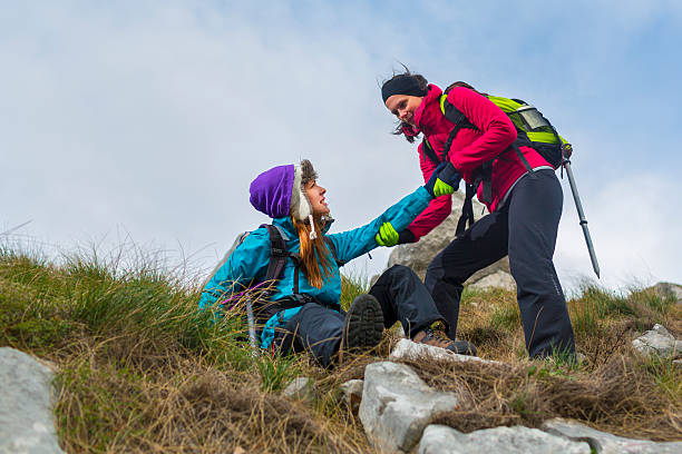istock Hiking accident with injured hiker on hilltop 450210871