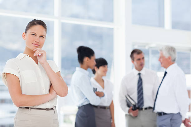 istock Thoughtful businesswoman with her team behind 450226591