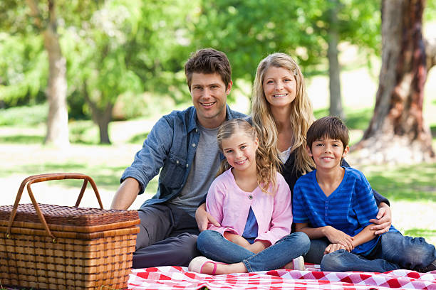 istock Lovely family sit on the blanket getting ready to eat 450227881