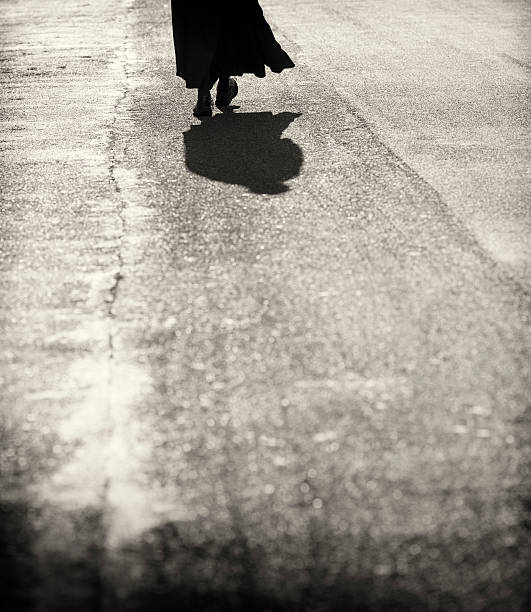 Italian priest walking on asphalt silhouette, Rome Italy
