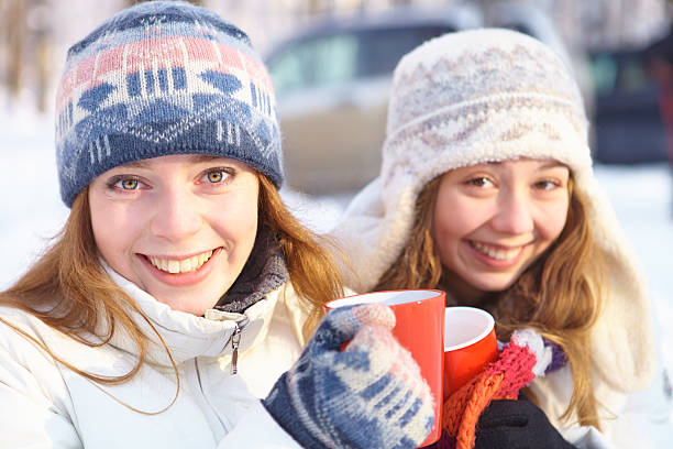 istock Outdoors on a winter day. Girls drink tea. 450232913