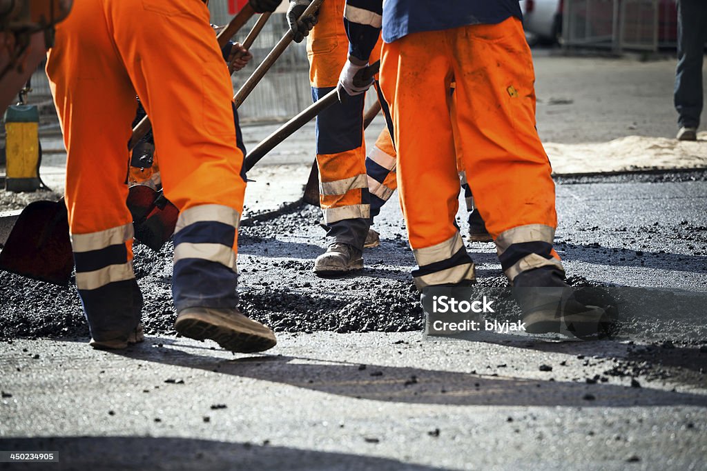 Workers on road construction Workers on a road construction, industry and teamwork Road Construction Stock Photo