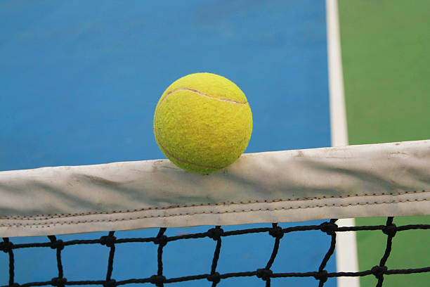 istock tennis ball on net 450234913