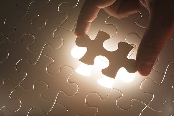 istock Hand holding the last piece of jigsaw puzzle 450236831