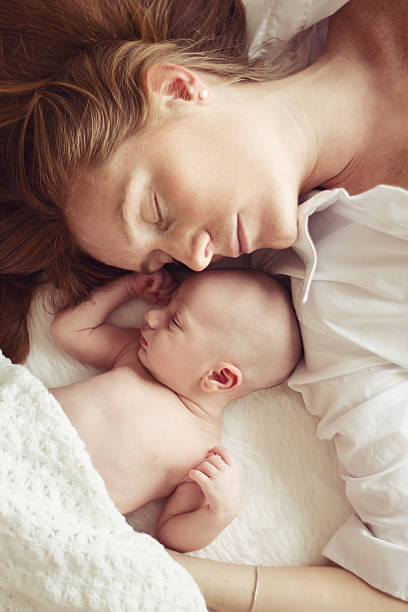 istock Sleeping young mother and newborn baby 450242369