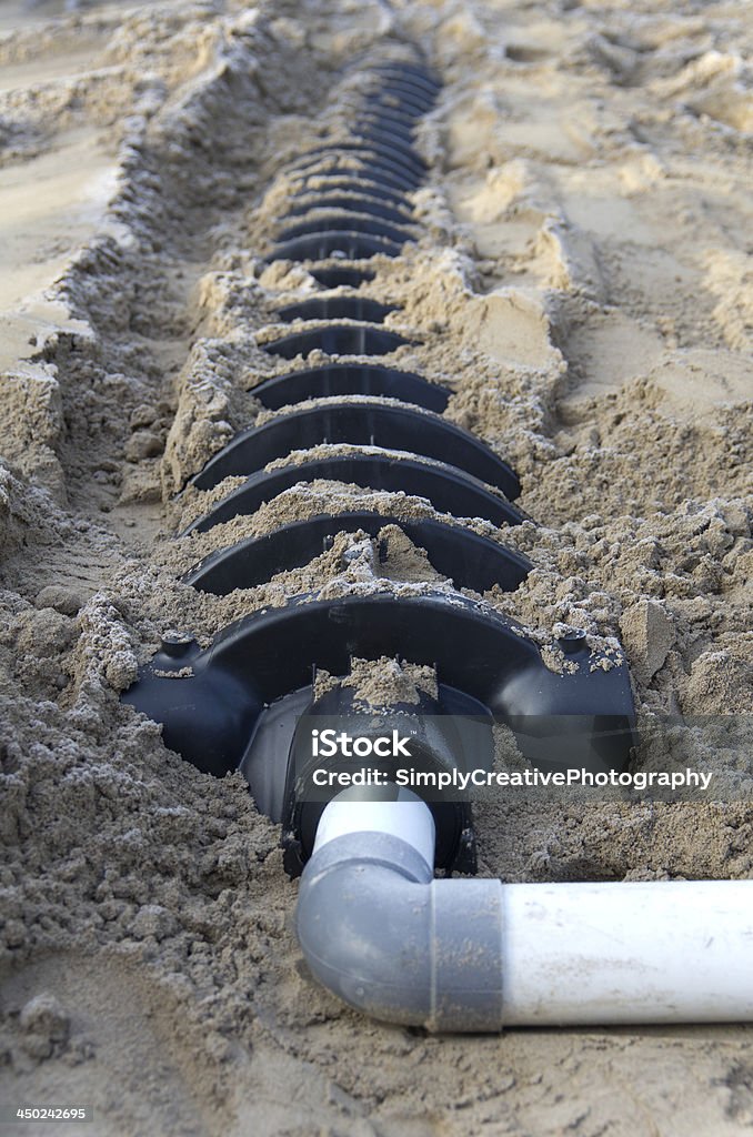 Raised bed at a construction site Construction site view of a raised bed sand filled weeping bed drainage line. Drainage Stock Photo