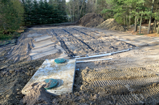Construction site view of a septic tank and raised bed sand filled weeping bed.