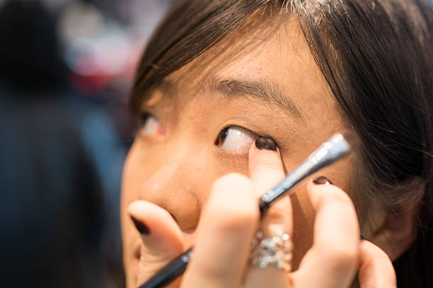 istock Woman applying cosmetics 450242853