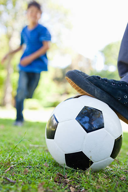istock Ball about to be kicked by a boy 450243713