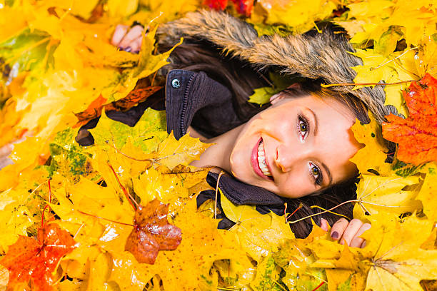 istock Girl and maple leaves 450250821