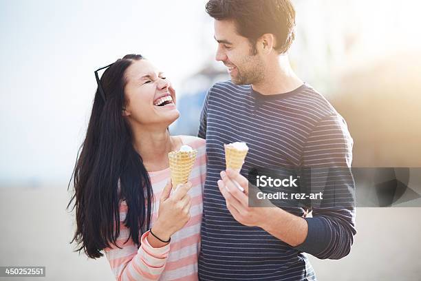 Young Couple Eating Ice Cream And Smiling Stock Photo - Download Image Now - 20-29 Years, Activity, Adult