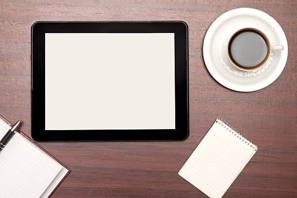 istock empty tablet and a cup of coffee in office 450259989