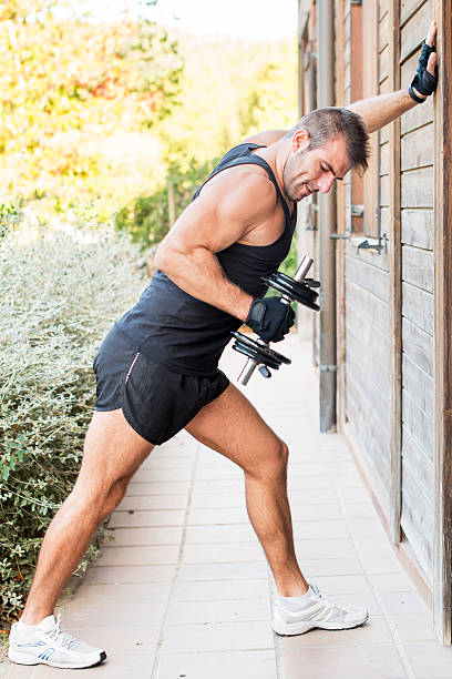 istock Man exercising dumbbell outdoor. 450261611