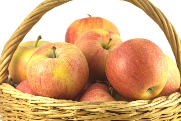 istock Ripe apples in basket isolated closeup 450265485