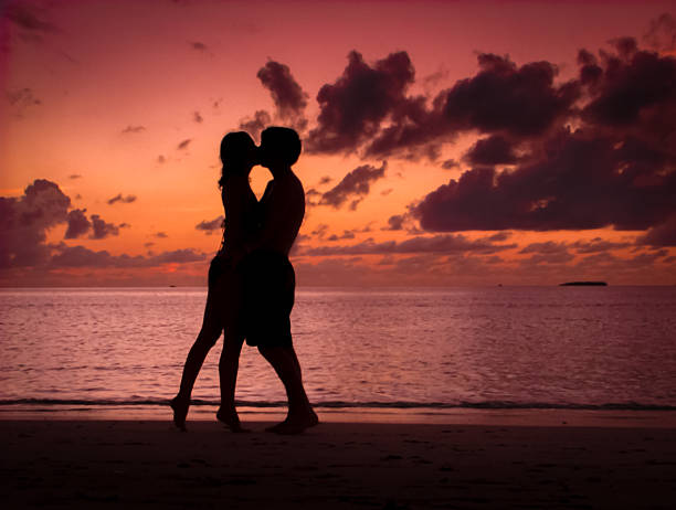 istock Couple Kissing on a Beach at Sunset 450266147