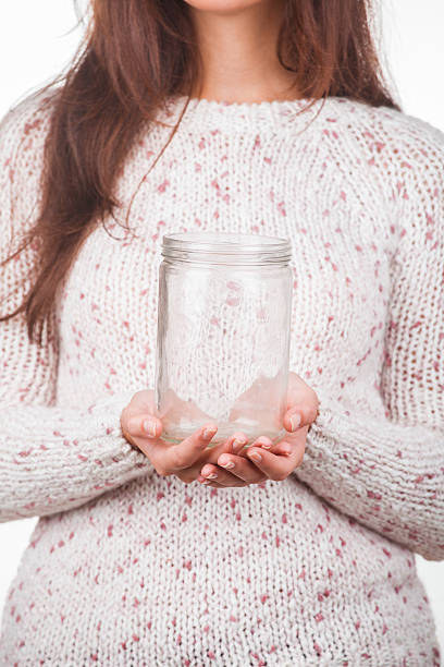 istock Portrait of a young girl with empty jar 450274869