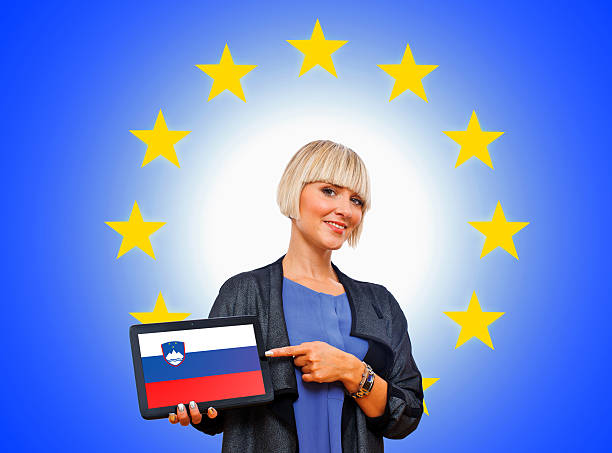 istock woman holding tablet with slovenian flag 450278905