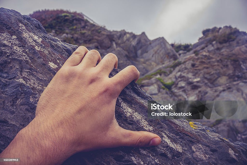 Man's hand on rock Close up on a young man's hand as he is climbing a rock Rock Climbing Stock Photo