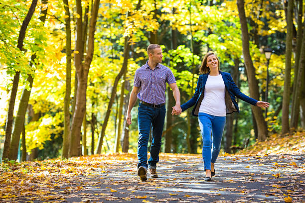 istock Young couple walking in park 450282407