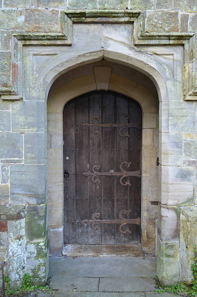 istock Arched doorway with oak wood door. 450283305