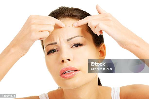 Young Woman Squeezing Spot On Her Forehead Stock Photo - Download Image Now - Adult, Beauty Treatment, Close-up