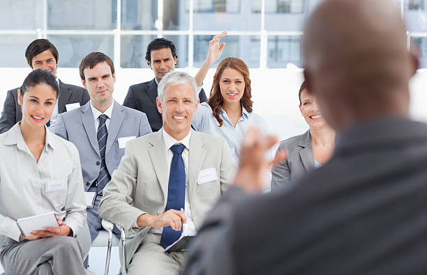 istock Woman raising an arm to query her colleague 450292829