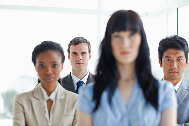 istock Businesswoman accompanied by her serious team 450300917