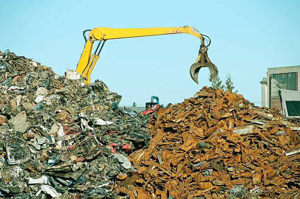 istock Crane with grapple tool at metal recycling plant 450303391