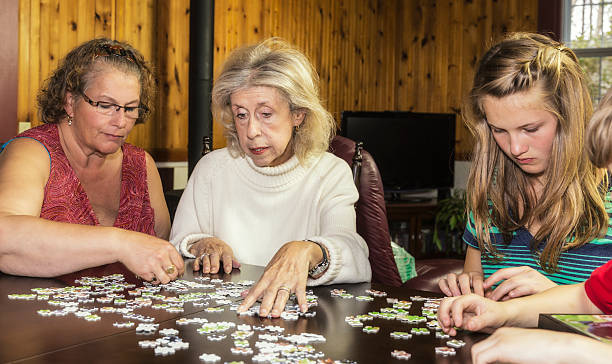 istock Grandmothers And Grandchildren Assembling Jigsaw Puzzle 450304753