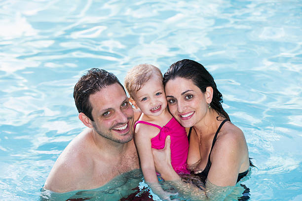 istock Hispanic family in swimming pool 450305699