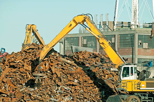 istock Two cranes with magnets moving scrap metal onto pile 450309123
