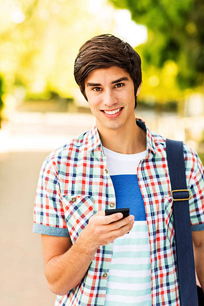 istock Confident Teenage Student With Smart Phone On Campus 450309583