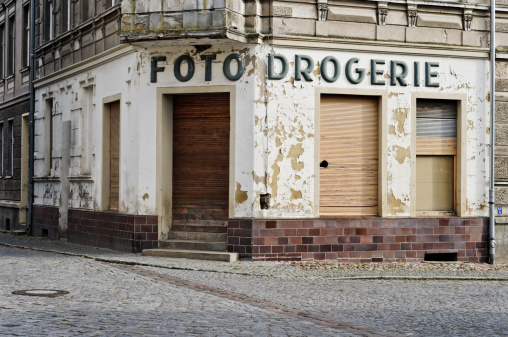 Old house facade. Empty house with a former photo and drugstore. Germany, Brandenburg, Buckow