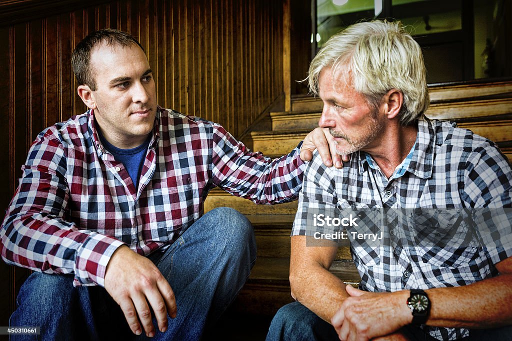 Friend in Need A good friend sits down and reaches out to a troubled friend. 40-44 Years Stock Photo