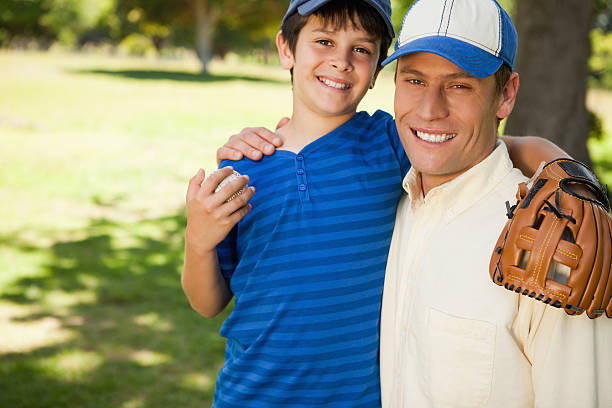 istock Smiling father and son looking at the camera 450310889