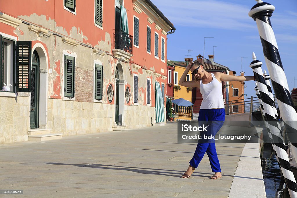 woman and Venice A beautiful blond model standing infront of an italien building enjoying herself. Natural light. 20-24 Years Stock Photo