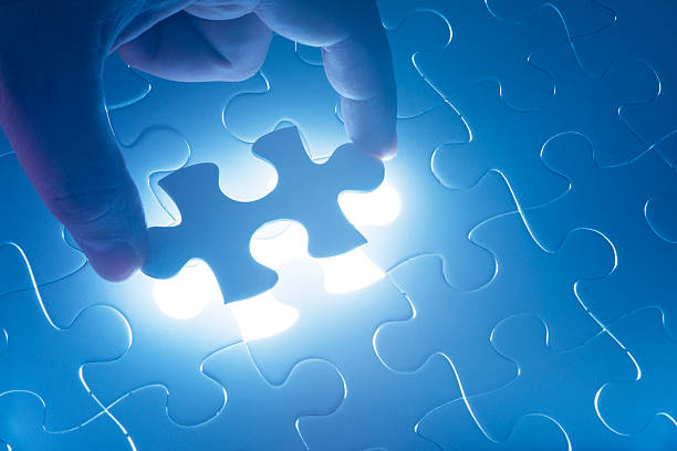 istock Hand holding the last piece of jigsaw puzzle 450324839