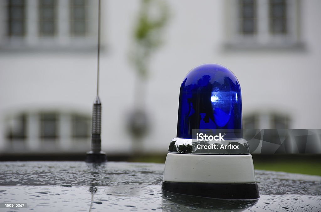 blue emergency vehicle lighting blue police light shining on an old police car in Denmark Alertness Stock Photo