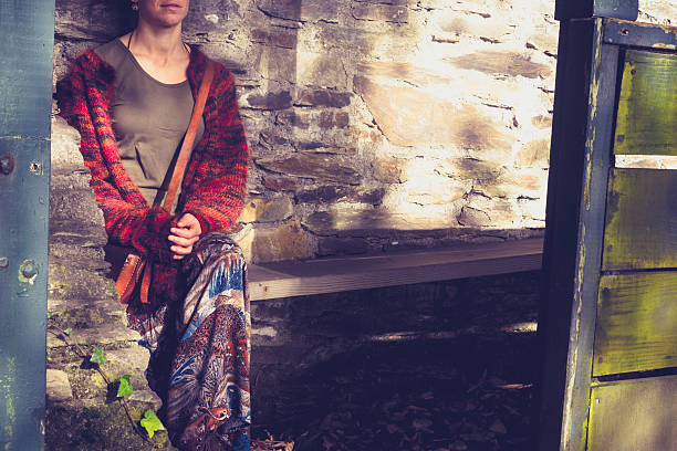 istock Woman waiting for bus at rural shelter 450366233