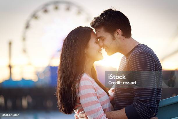 Romantic Couple Embracing At Sunset Stock Photo - Download Image Now - Adult, Adults Only, Affectionate