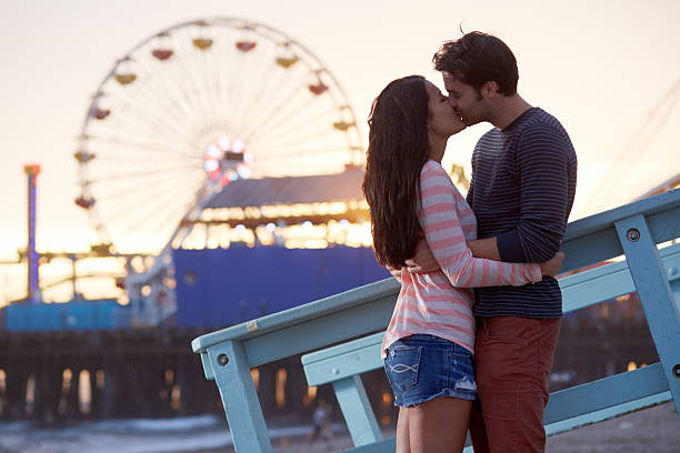 istock romantic couple kissing at sunset 450395453