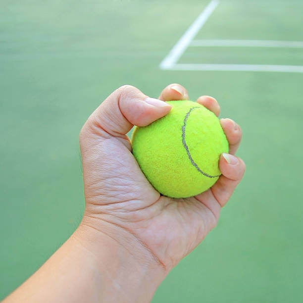 istock Tennis ball in hand 450405813