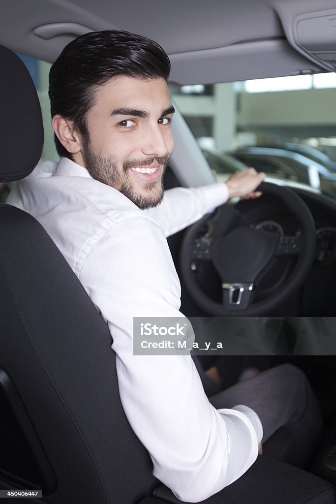 Handsome men in a car Handsome man in car dealership sitting in the car at car dealership 30-39 Years Stock Photo