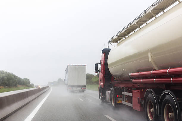 Trucks on a wet road Overtaking large trucks on a wet road truck rain stock pictures, royalty-free photos & images