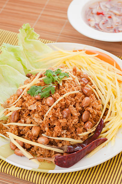 Crispy catfish with green mango salad, popular food in Thailand. stock photo