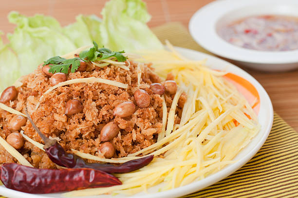 Crispy catfish with green mango salad, popular food in Thailand. stock photo