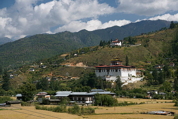 istock Rinpung Dzong fortress-monastery and rice fields, Paro, Bhutan 450418337