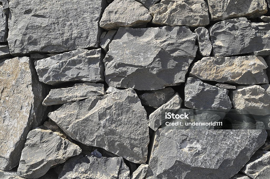 Gray Rock Ancient Wall Texture Gray Rock Ancient Wall made of Volcanic Rocks Abstract Stock Photo