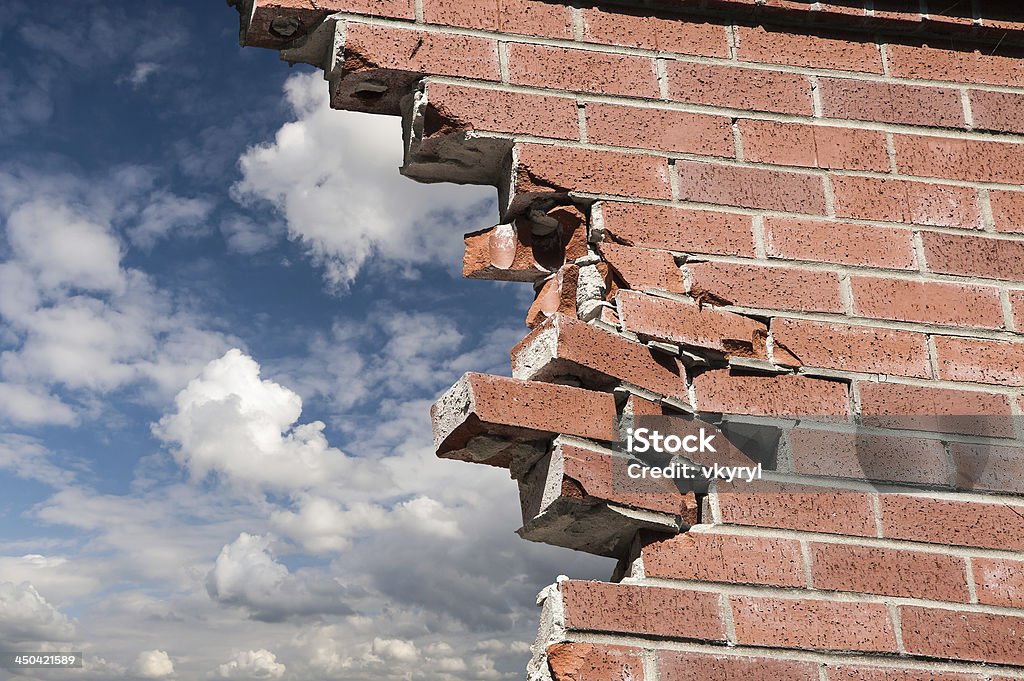 Escape Broken brick wall and blue sky with clouds. Wall - Building Feature Stock Photo